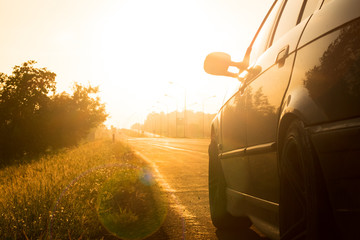 Angle shot of a car against golden sunlight in the background