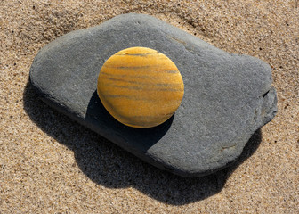 Jupiter Stone On Gray Rock On Sand Beach