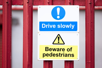 Beware of pedestrians drive slowly sign