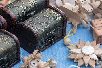 Wooden products and small metal chests on the counter of the street market