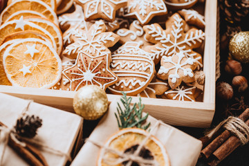 Christmas scene. Holiday greeting card design. Traditional festive gingerbread cookies, handmade gift boxes and natural decorations