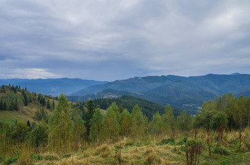 Fototapeta na wymiar Beautiful autumn mountain forest landscape. Clouds over the rocks.
