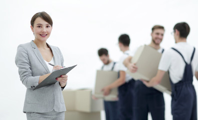 Woman manager holding clipboard on blurred background with mover