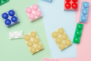 Some toy bricks on colored background. Top view. Flat lay