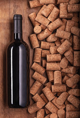 Black glass bottle of wine on corks and wood background Poster concept design photo shooting