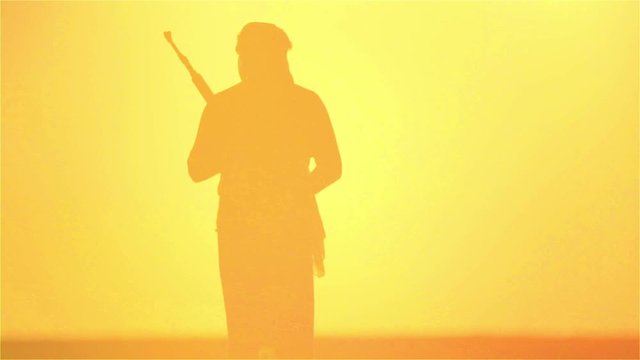 warrior with Kalashnikov at sunset day. fighter is training with a machine gun at sunset.