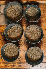 Freshly roasted aromatic coffee beans over a modern coffee roasting machine. View from above