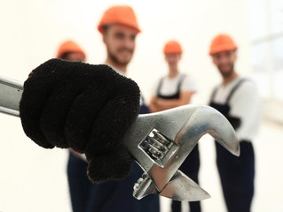 closeup. the wrench in the hands of the builders