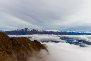 Roy's Peak Snow Capped Mountains above Clouds New Zealand