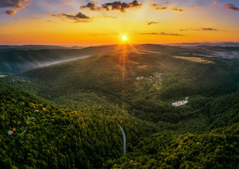 Aerial view of green valley during colorful sunset