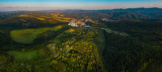 Aerial view of green valley during colorful sunset