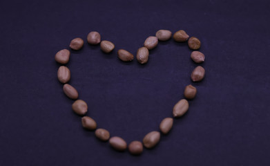 Beautiful heart of the peanuts on the black background. Valentine's day. Symbol of lovers. Retro style.
