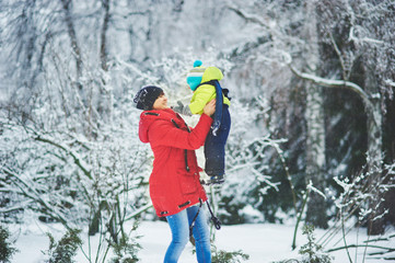 Fototapeta na wymiar a happy family. mother and three children playing in the winter forest.
