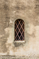 An old window in the narrow streets in the medieval town of Massa Marittima in Tuscany