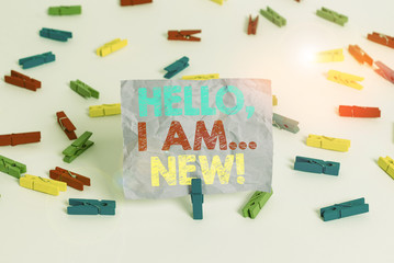 Writing note showing Hello I Am New. Business concept for introducing oneself in a group as fresh worker or student Colored clothespin papers empty reminder white floor background office