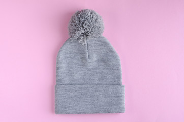 Gray cotton hat composition on pink background. Flat lay.