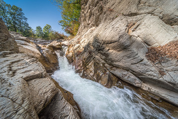 The flow of water between stones in a mountain river