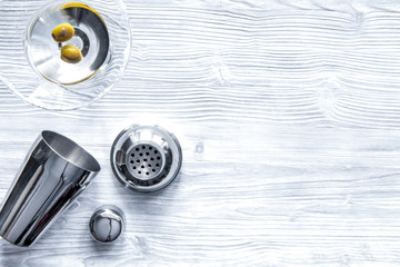 martini and shaker top view of wooden background