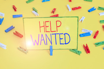 Word writing text Help Wanted. Business photo showcasing An ad in the paper an employer places to find a new employee Colored clothespin papers empty reminder yellow floor background office