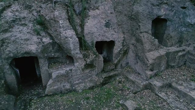 Slow zoom out of ancient houses and building digged into the tuff rock SF