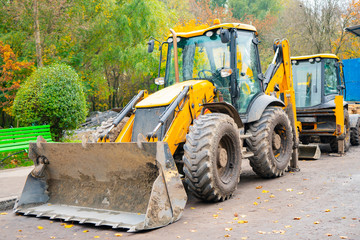 yellow excavator stands on the construction site