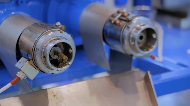 Close up view - pet food and oil extruder machine: mixed feed production line at factory, plant, exhibition, trade show. Farming, extrusion technology, agriculture industry, animal husbandry concept