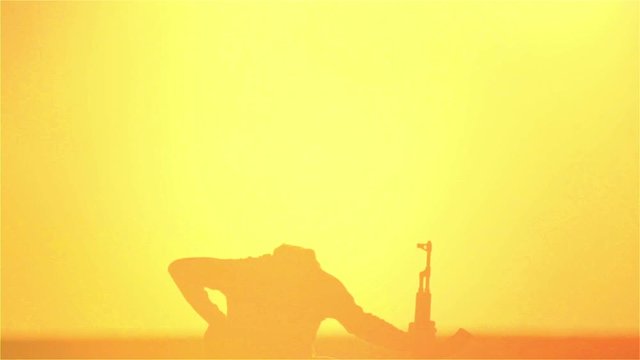 warrior with Kalashnikov at sunset day. fighter is training with a machine gun at sunset.