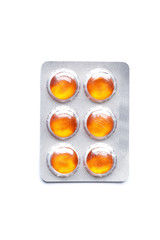 Orange Blisters with color cough drops isolated on a white background.
