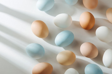 Natural Colored Eggs with sunlights. Compositions in pastel colors. Easter consept.  Flat lay, top...