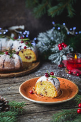 Traditional homemade christmas cake holiday dessert with cranberry and chocolate with new year tree decoration on vintage wooden table background. Rustic style.