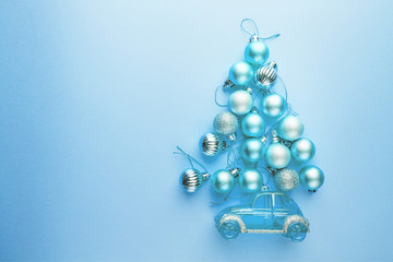 Christmas tree made of Christmas balls on blue background. Minimal styled New Year banner.