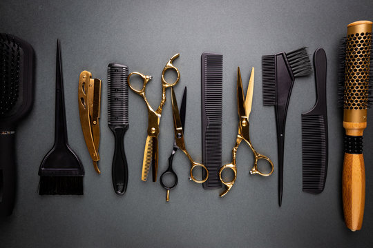 Various hair dresser and cut tools on black background with copy space