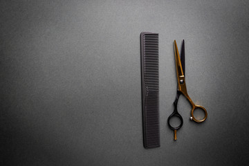 Various hair dresser and cut tools on black background with copy space