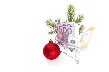concept of purchases before Christmas, New Year's decor and a 500-euro note in a shopping trolley on a white background copy space isolation