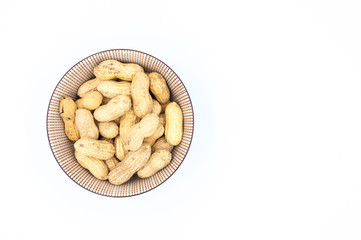 peanuts in shells in a bowl isolated on white background
