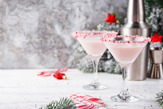 Pink peppermint martini with candy cane rim