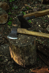 Old chopping axe on wooden stump.