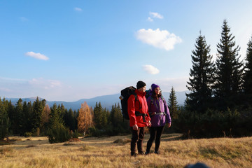 Girl and man hikers in mountains. Travel backpacks and clothing. Campaign. Ukrainian Carpathian Mountains. Traveling in Ukraine.Couple