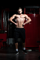 Fototapeta na wymiar Man In Gym Showing His Well Trained Body