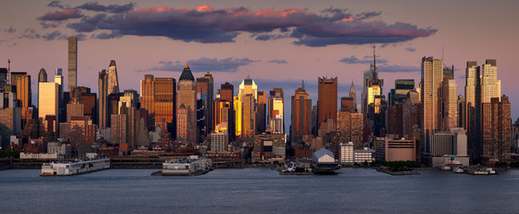New York City sunset on Midtown West skyscrapers. Panoramic view on Manhattan and the Hudson River banks. NY, USA