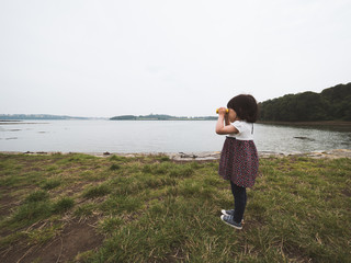 toddler girl playing exploration  at foggy  summer countryside,Northern Ireland