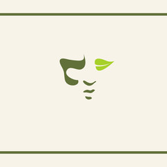 Silhouette of Human unisex face. A leaf like an eye. Shadow on face. Green colour. Natural herbal cosmetics. Logo design template.