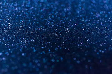 Abstract glitter shining lights background. De-focused lights