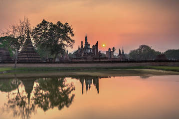 Fototapeta na wymiar Wat Maha That temple at Sunset in Sukhothai historical park, A World Heritage site, in Central Thailand 
