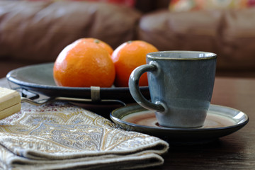 Morning coffee table background with fresh orange 