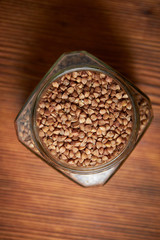 buckwheat in a jar closeup on a brown wood background