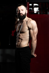 Fototapeta na wymiar Bodybuilder Performing Side Triceps Pose