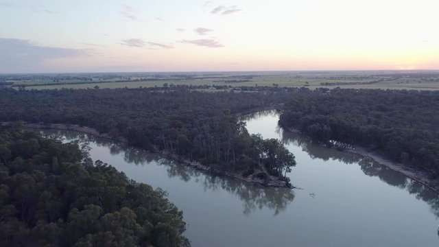Forward flight over Murray River bend at sunset in Moama, NSW, Australia