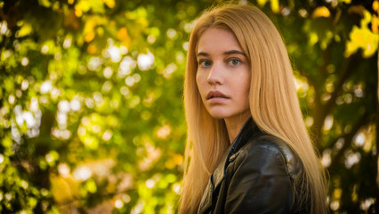Portrait of a beautiful blonde girl in the park.