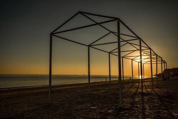 Metal structures on the seashore in the evening.